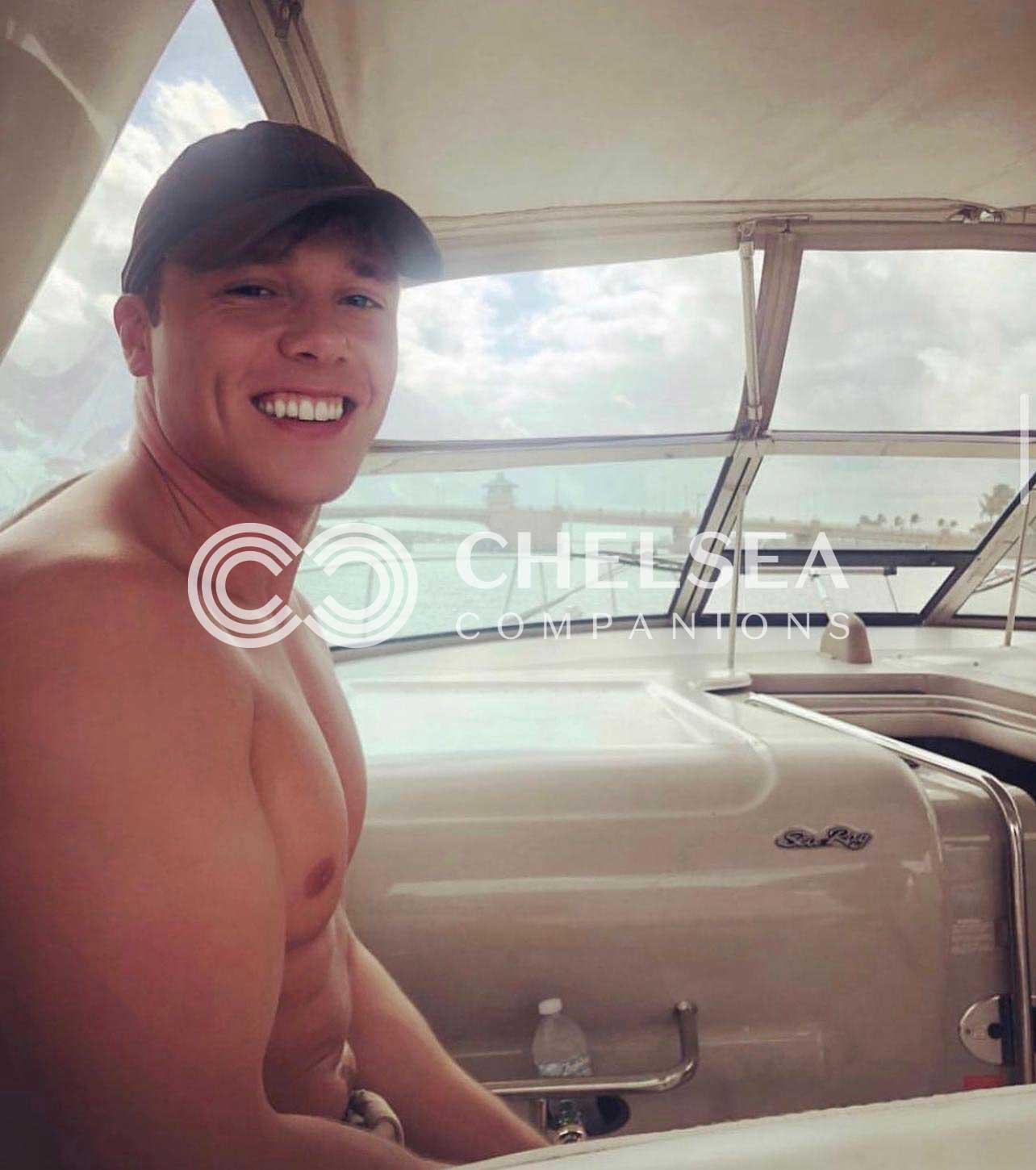 Joshua topless on a boat